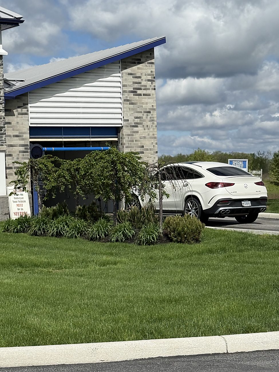 A car beside the Ultra Car Wash building