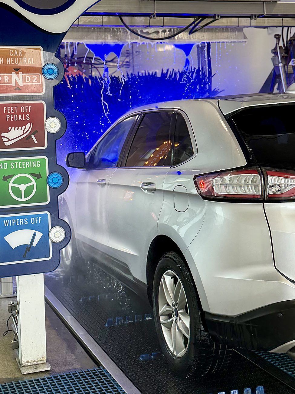 An SUV entering the Ultra Car Wash tunnel
